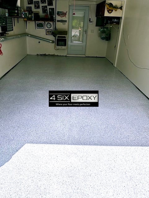 Garage interior with gray speckled epoxy floor and 4Six Epoxy logo watermark, white sample swatch in foreground